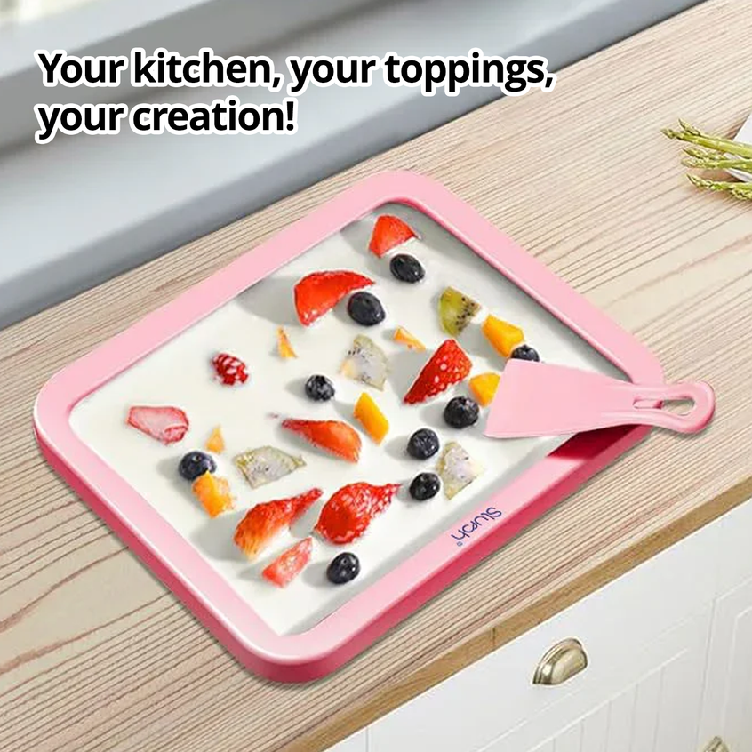 Slursh Pink ice cream making tray with fruits and a spatula on a wooden surface, text 'Your kitchen, your toppings, your creation!'.
