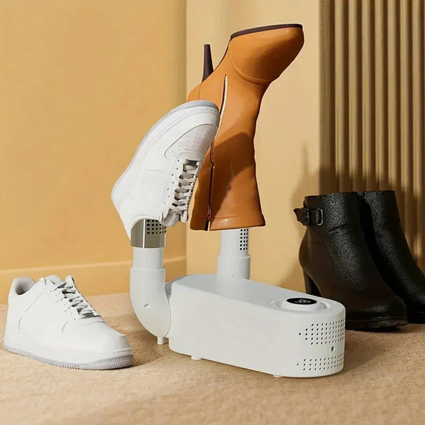 Portable Shoe dryer drying white sneakers, brown boots, and black boots on a beige background