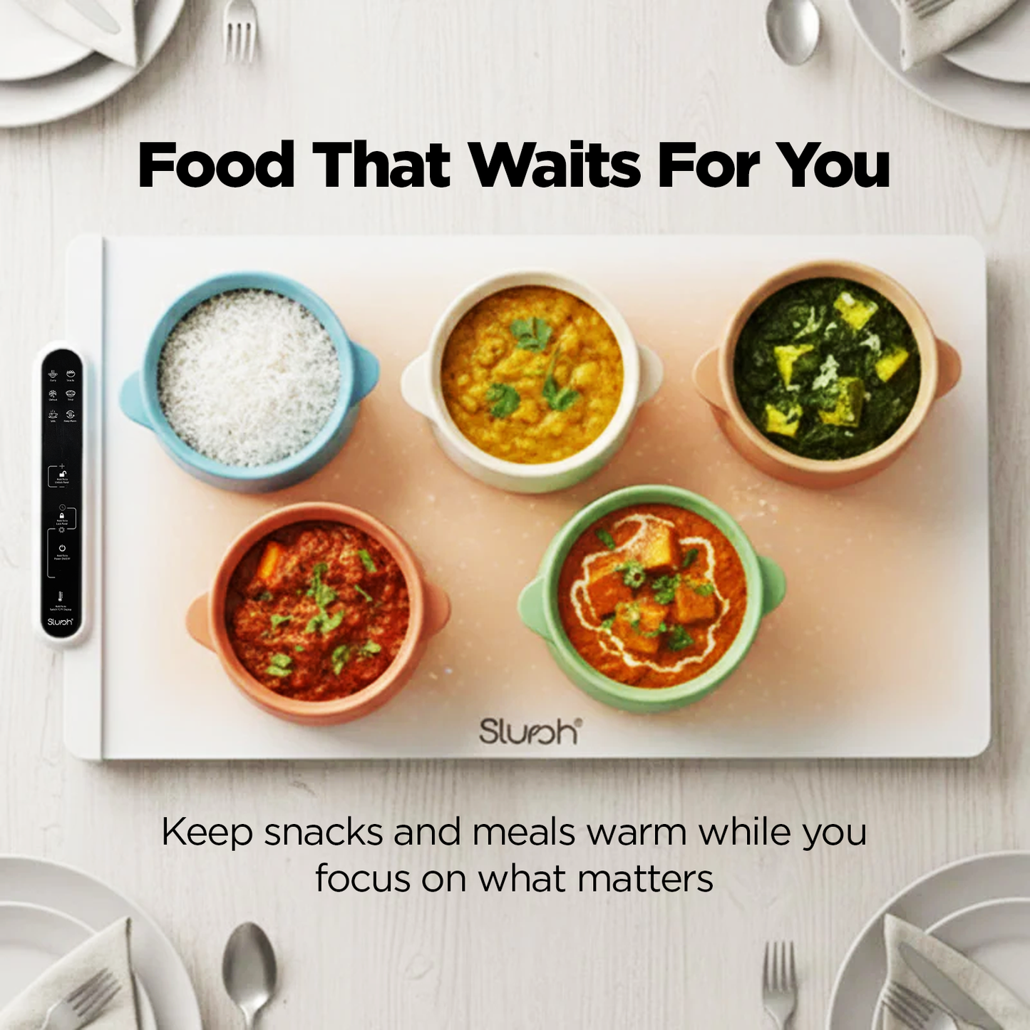 Slursh food warming tray with various dishes on a white surface