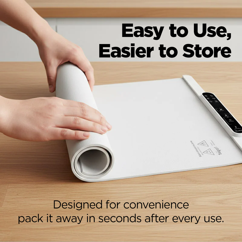 Person rolling white  Slursh food warming mat on a wooden surface with text about its ease of use and storage.