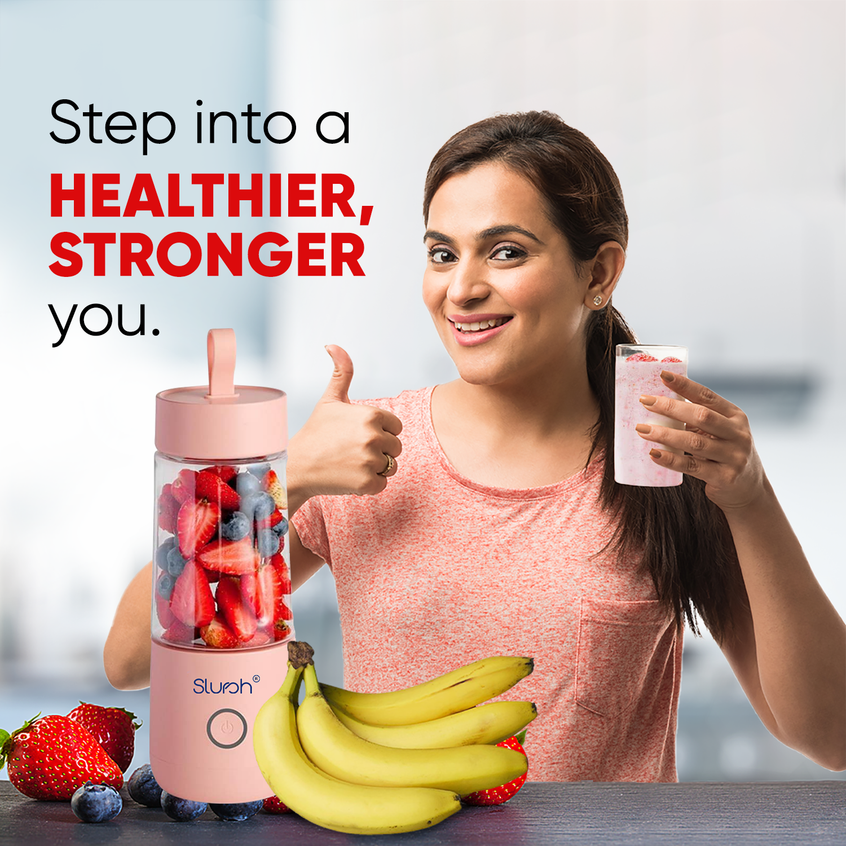 Woman holding pink Slursh Bolt 350 ML portable blender and glass with text 'Step into a Healthier, Stronger You'.