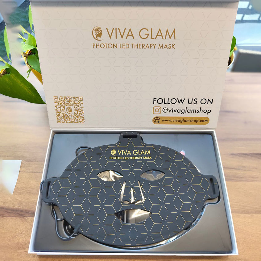 VIVA GLAM Photon LED Therapy Mask in packaging on a wooden surface with plant in the background
