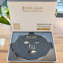 VIVA GLAM Photon LED Therapy Mask in packaging on a wooden surface with plant in the background