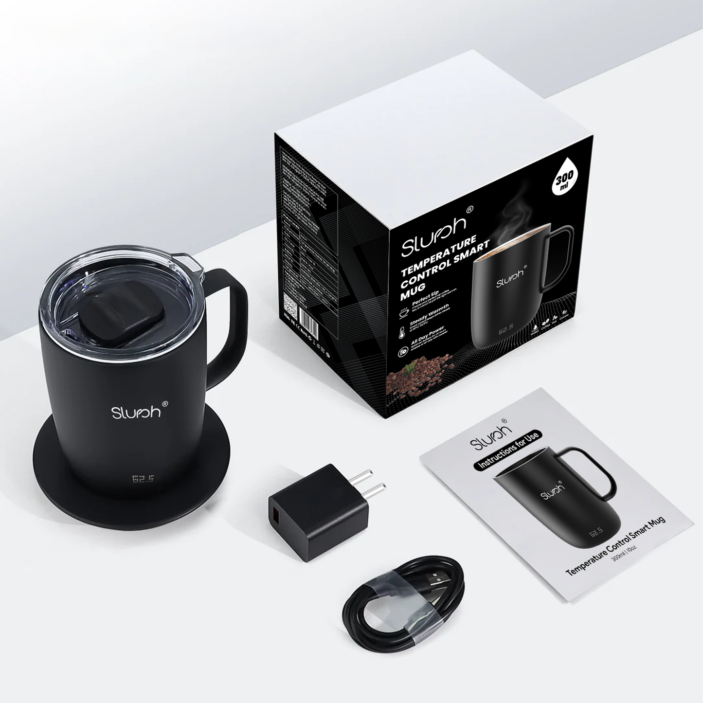 Black Slursh temperature control smart mug, packaging, and accessories on a white background